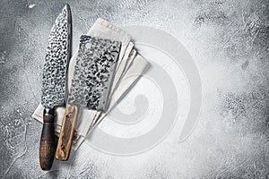 Hatchets for meat, Vintage butcher meat cleaver with cloth towel on wooden board. White background. Top view. Copy space