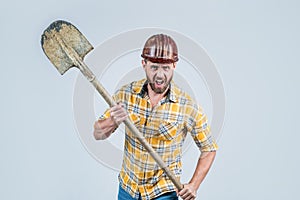 hate his job. man architect with shovel. guy wear worker uniform. handsome builder in helmet. mature man wear checkered