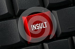 A Black keyboard with a red key and the insult word photo