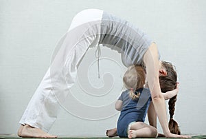 Hatha yoga fitness mother with baby.