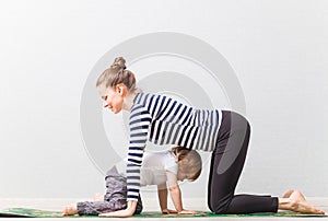 Hatha yoga fitness mother with baby home