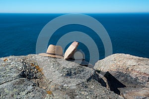 Hats and bag still lifes on rock photo