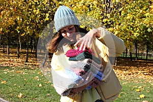 Hats crocheted knitted in the hands of a girlon the street. Product listing for sale. Urban style. Fashion. Autumn