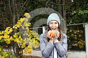 Hats crocheted knitted in the hands of a girlon the street. Product listing for sale. Urban style. Fashion. Autumn