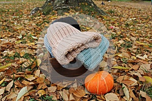 Hats crocheted knitted in the hands of a girlon the street. Product listing for sale. Urban style. Fashion. Autumn