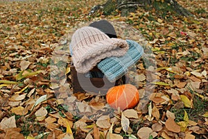 Hats crocheted knitted in the hands of a girlon the street. Product listing for sale. Urban style. Fashion. Autumn