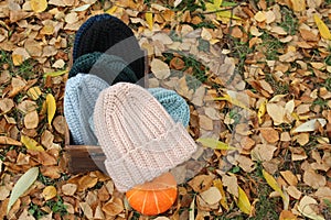 Hats crocheted knitted in the hands of a girlon the street. Product listing for sale. Urban style. Fashion. Autumn