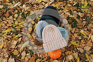 Hats crocheted knitted in the hands of a girlon the street. Product listing for sale. Urban style. Fashion. Autumn