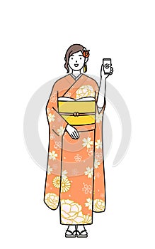 Hatsumode at New Year\'s and coming-of-age ceremonies, weddings, etc, Woman in furisode using a smartphone