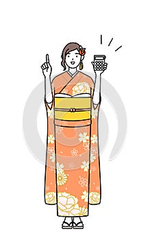 Hatsumode at New Year\'s and graduation ceremonies, weddings, etc, Woman in furisode holding a calculato