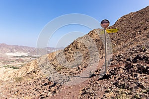 Trail signpost with directions on a mountain hiking trail in Hatta, Hajar Mountains, United Arab Emirates