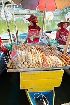 Woman selling fish cake sticks at Klong Hae floating market, Hatyai, Thailand