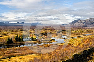 Haukadalur valley in Iceland. Beautiful landscape with river in valley. Little buildings in peaceful nature environment