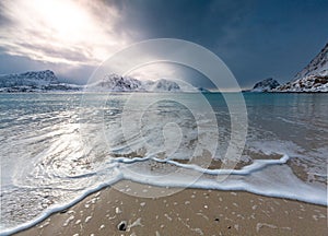 Haukland beach in winter with waves, amazing mountains around, Lofoten