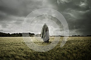 Haunted Spirit Ghost Floating Through a Bleak Landscape photo