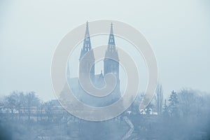 Haunted church - Old Vysehrad Basilica of saint Peter and Pavel covered in fog during foggy day photo