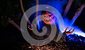 Haunted Halloween theme, Animated spooky pumpkin with smoke lights and signs in darkness surrounded by trees