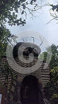 A haunting image of an owl statue shrouded in mystery and darkness.