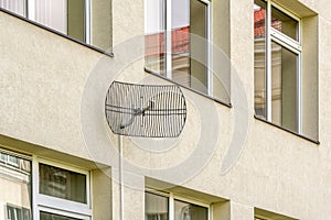 Hause facade with windows and wireless communication antenna