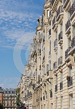 Haussmann apartments line streets in Paris under a blue sky