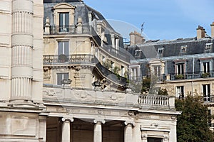 Haussmann style buildings were built near a public garden in Paris (France)