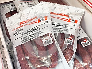 HauswÃ¼rstel packaging display with austrian branding in a store setting