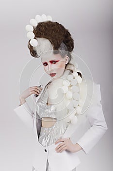 Haute Couture. Extravagant Woman in Cyber Costume and Theatrical Hair-do