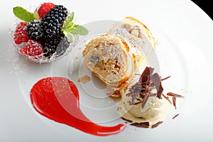 Haute cuisine, strudel with ice cream and berries dessert on restaurant table