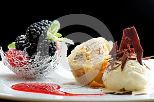 Haute cuisine, strudel with ice cream and berries dessert on restaurant table
