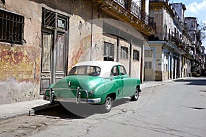 HAVANA, CUBA - 20 December 2016 : Old American cars are still a common sight in the backstreets of Havana, Cuba. Many are used as