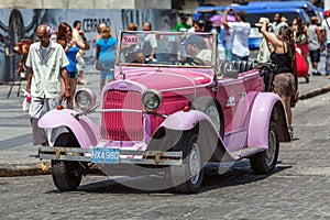 HAVANA, CUBA - APRIL 1, 2012: Really old antique car in front of