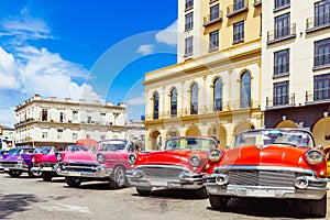 American red 1955, 1956 convertible, pink 1957 convertible and a 1958 convertible vintage car