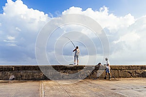 Cuban fishermen fishing at the morning on the Malecon in Havana Cuba - Serie Cuba Reportage