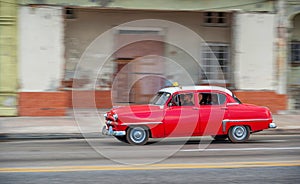 HAVANA, CUBA - OCTOBER 20, 2017: Havana Old Town and Malecon Area with Old Taxi Vehicle. Cuba. Panning.