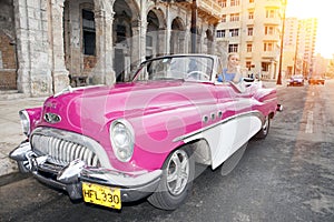 HAVANA- JANUARY 27, 2013: The beautiful woman at a wheel old American retro car 50th years of the last century, an iconic sight