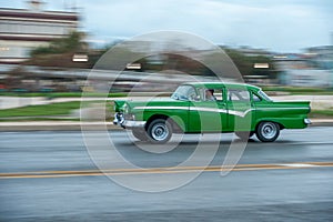 HAVANA, CUBA - OCTOBER 20, 2017: Havana Old Town and Malecon Area with Old Taxi Vehicle. Cuba. Panning.