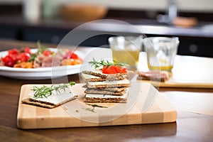 havarti cheese layered on rye crackers, fresh on wooden plank
