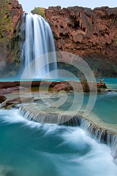 Havasu Falls, famous for its blue green water, appears like satin as it cascades along lower rocks