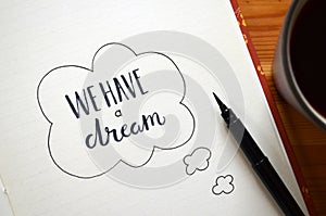 WE HAVE A DREAM hand-lettered in notebook