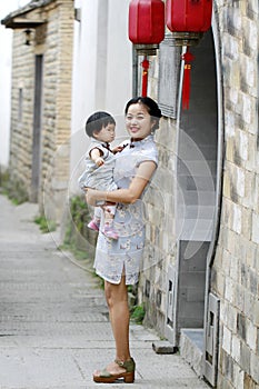 Have fun with monther, Chinese classic woman and baby in cheongsam