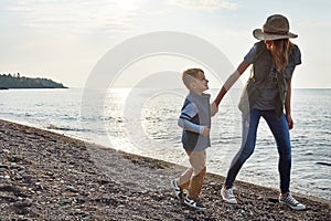 We have fun wherever we go. a young woman and her son enjoying a walk by the water.