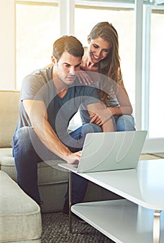 Have a look at this. a young couple using a laptop at home.