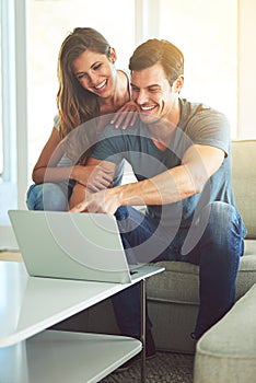 Have a look at this. a young couple using a laptop at home.