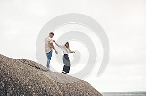 We always have more fun at the beach. a young couple spending the day together at the beach.