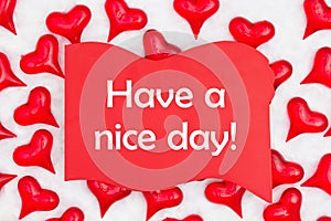 Have a nice day message on red wood sign with red hearts on white fabric