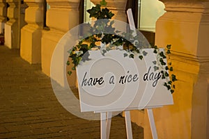 have a nice day sign outside a coffee shop on a tripod with flow