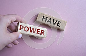 Have power symbol. Wooden blocks with words have power. Businessman hand. Beautiful pink background. Business and have power