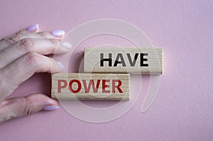 Have power symbol. Wooden blocks with words have power. Businessman hand. Beautiful pink background. Business and have power