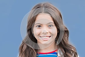 Have a smile on your lips. Happy child smile blue background. Small girl with healthy smile. Oral hygiene. Pediatric