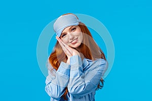 Have sweet dreams. Tender, lovely and feminine redhead teenage girl ready sleep tight, wearing sleeping mask and pyjama